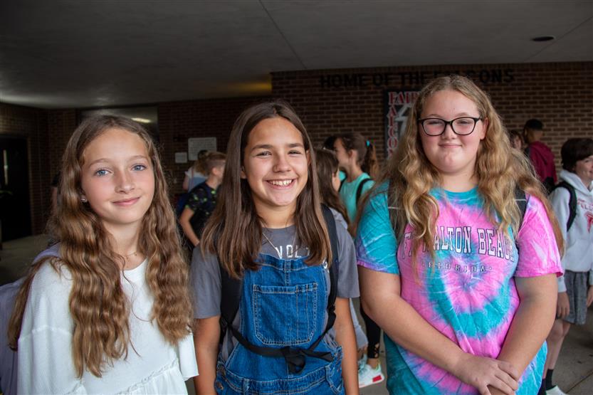 Three girls smile
